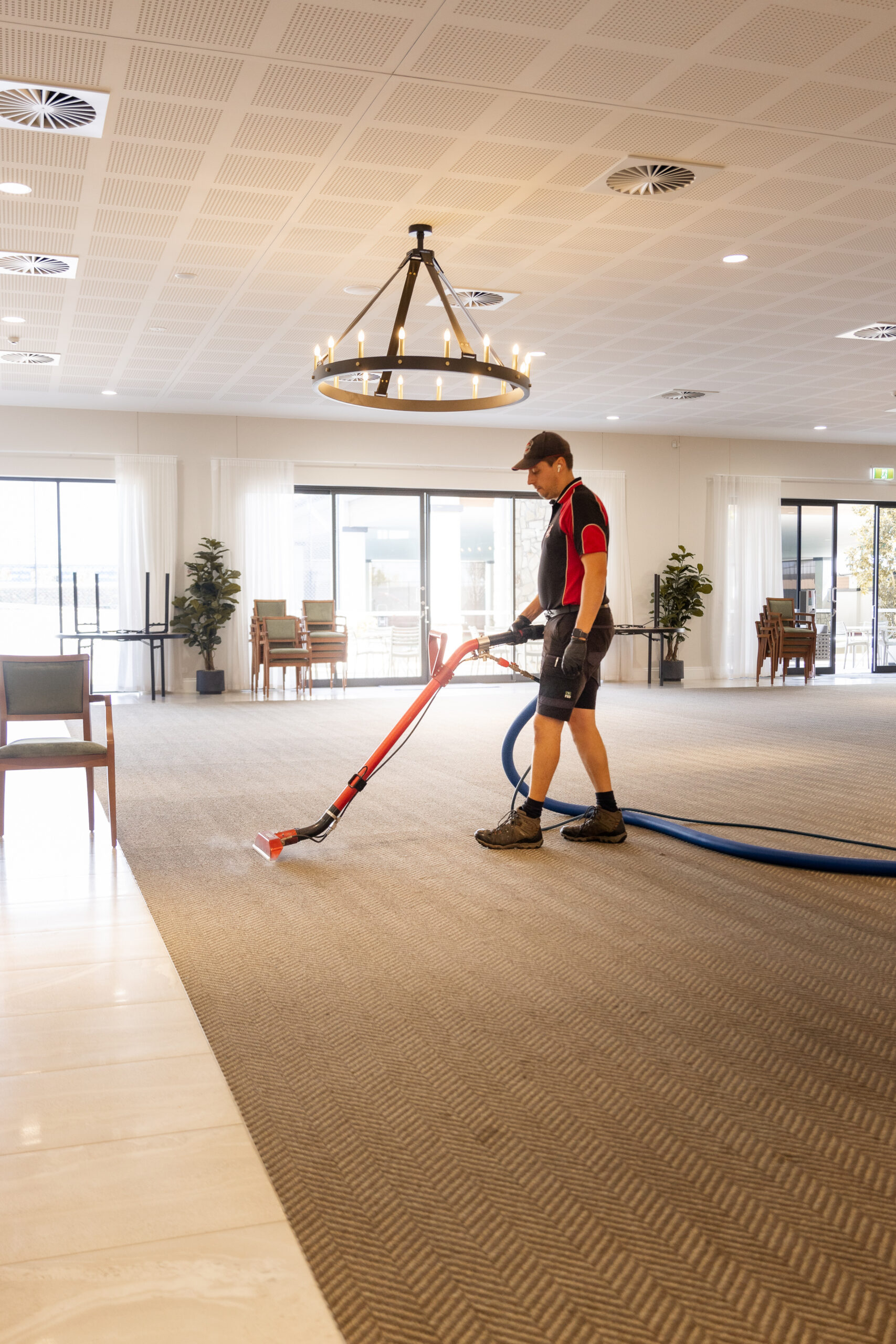 Professional cleaner cleaning the carpet in a commercial space
