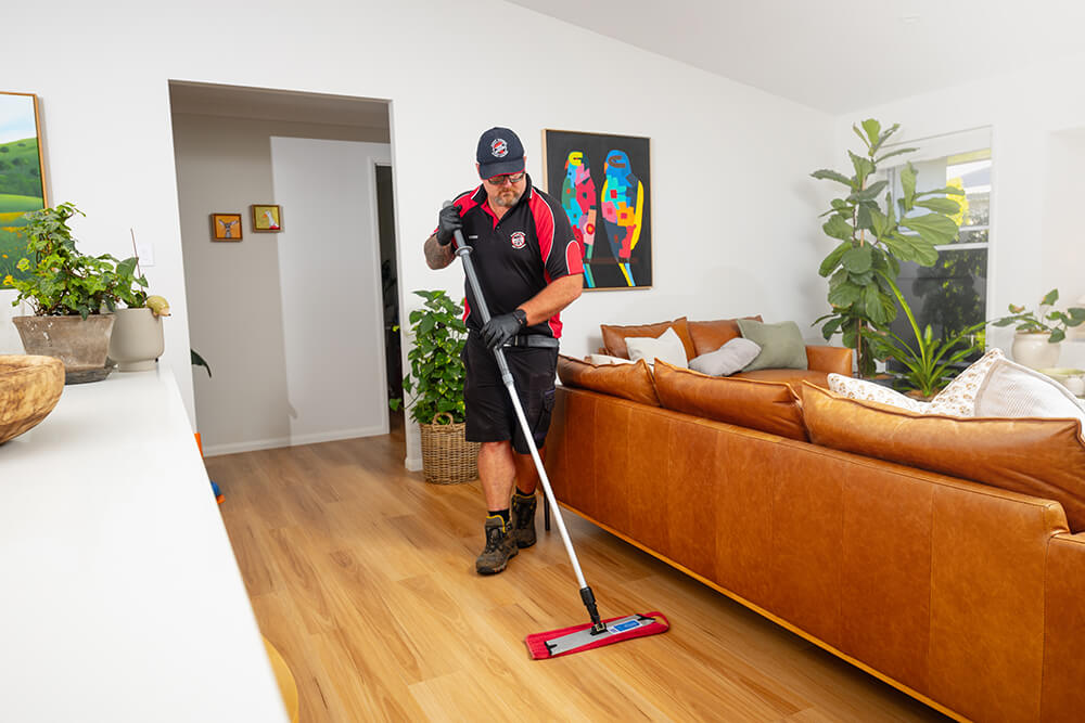 One of our professional cleaners mopping a vinyl floor
